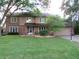 Charming two-story home with a brick facade, well-maintained lawn, and mature trees at 1327 Goldfinch Dr, Carmel, IN 46032
