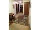 Hallway with carpet, with wooden furniture, artwork, and an area rug at 1327 Goldfinch Dr, Carmel, IN 46032
