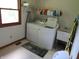 Convenient laundry room with washer, dryer, sink, and storage shelves for organized living at 1327 Goldfinch Dr, Carmel, IN 46032