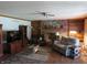 Cozy living room with a brick fireplace, built-in shelves, hardwood floors, and comfortable seating at 1327 Goldfinch Dr, Carmel, IN 46032