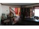 View of living room that features a staircase, wood trim, piano, and hardwood floors at 1327 Goldfinch Dr, Carmel, IN 46032