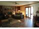 Comfortable living room with fireplace, ceiling fan, hardwood floors, and access to backyard at 1327 Goldfinch Dr, Carmel, IN 46032