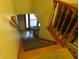 An interior view of a wooden staircase with carpet stair treads leading down towards a door at 1327 Goldfinch Dr, Carmel, IN 46032