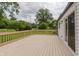 A back deck overlooking a yard with trees and green grass, as well as a view of the power lines at 1537 Mutz Dr, Indianapolis, IN 46229