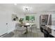 Dining area featuring a modern chandelier, table with chairs, and stainless steel refrigerator at 1537 Mutz Dr, Indianapolis, IN 46229