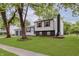 Split-level home on a large lot with mature trees and a well-maintained lawn at 1537 Mutz Dr, Indianapolis, IN 46229