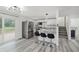 View of a modern eat-in kitchen with a breakfast bar and stainless steel appliances at 1537 Mutz Dr, Indianapolis, IN 46229