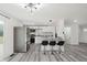 Eat-in kitchen with stainless steel appliances, modern bar stools, and white cabinets at 1537 Mutz Dr, Indianapolis, IN 46229