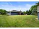 Large backyard featuring well-maintained grass, mature trees, and the rear of the home at 180 Wellington Pkwy, Noblesville, IN 46060