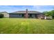 Large backyard featuring well-maintained grass, a wooden deck, and the rear of the home at 180 Wellington Pkwy, Noblesville, IN 46060