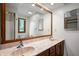 Bathroom featuring double vanity sinks, a framed mirror, and storage cabinet at 180 Wellington Pkwy, Noblesville, IN 46060