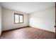 Bright bedroom features wood-look flooring, neutral walls, and a window providing ample natural light at 180 Wellington Pkwy, Noblesville, IN 46060