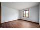 This bedroom features wood-look flooring, neutral walls, and a window providing ample natural light at 180 Wellington Pkwy, Noblesville, IN 46060
