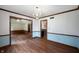 Open dining room with wood floors, decorative molding, and view of the kitchen at 180 Wellington Pkwy, Noblesville, IN 46060