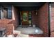 Close-up of a beautiful wooden front door and brick exterior with decorative trim at 180 Wellington Pkwy, Noblesville, IN 46060