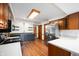 Updated kitchen with two-tone cabinets, floating shelves, stainless steel refrigerator and wood-look flooring at 180 Wellington Pkwy, Noblesville, IN 46060