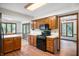 Efficient kitchen featuring wooden cabinetry, black appliances, and laminate countertops at 180 Wellington Pkwy, Noblesville, IN 46060