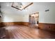 Spacious living room with wood-look floors, ceiling fan, and wainscoting at 180 Wellington Pkwy, Noblesville, IN 46060