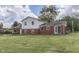 Spacious backyard features a red brick exterior, and well-maintained lawn at 1924 W 65Th Pl, Indianapolis, IN 46260