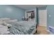 Well-lit bedroom with a full bed, blue accent wall, and closet at 1924 W 65Th Pl, Indianapolis, IN 46260