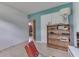 Bedroom with neutral walls, a large bookshelf, a lamp, and doorway to the rest of the house at 1924 W 65Th Pl, Indianapolis, IN 46260