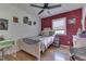 Cozy bedroom features hardwood floors, ceiling fan and colorful decor at 1924 W 65Th Pl, Indianapolis, IN 46260