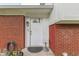 Close-up view of a white front door with a glass window, secured with an electronic lock at 1924 W 65Th Pl, Indianapolis, IN 46260