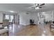 Spacious living area showcasing hardwood floors, a ceiling fan, and a dining area at 1924 W 65Th Pl, Indianapolis, IN 46260