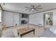 Gathering room with hardwood floors, fireplace, mounted television, and a ceiling fan at 1924 W 65Th Pl, Indianapolis, IN 46260