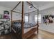 Main bedroom with a beautiful four-poster bed frame, fan, and lots of room for decor at 1924 W 65Th Pl, Indianapolis, IN 46260