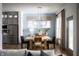 Well-lit dining room with modern light fixture and an open view to the kitchen at 19796 Chatham Shore Ln, Westfield, IN 46074