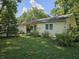 View of the front exterior with a well-maintained lawn and inviting blue front door at 2024 E 41St St, Anderson, IN 46013
