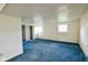 Spacious unfinished basement with white walls and blue carpet, offering ample potential at 2520 Tesh Dr, Indianapolis, IN 46203