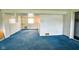 Unfinished basement area with painted walls, blue carpet, and access to a closet at 2520 Tesh Dr, Indianapolis, IN 46203