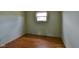 This bedroom features hardwood floors, one window, and light-colored walls at 2520 Tesh Dr, Indianapolis, IN 46203