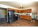 An open kitchen with stainless steel appliances and wood cabinets at 2520 Tesh Dr, Indianapolis, IN 46203