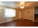 Living room with hardwood floors, a ceiling fan, a front door, window and adjacent staircase at 2520 Tesh Dr, Indianapolis, IN 46203