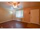 Living room with hardwood floors, a ceiling fan, front door, window and an adjacent lamp at 2520 Tesh Dr, Indianapolis, IN 46203