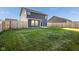 Spacious backyard with green grass, privacy fence and a patio at 341 Thistlewood Dr, Greenfield, IN 46140