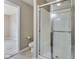 Well-lit bathroom featuring a glass enclosed shower, toilet, and vinyl floors at 341 Thistlewood Dr, Greenfield, IN 46140