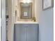 Stylish powder room features framed mirror and single sink vanity at 341 Thistlewood Dr, Greenfield, IN 46140