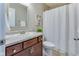 Bright bathroom featuring a modern vanity, toilet, shower curtain, and vinyl flooring at 341 Thistlewood Dr, Greenfield, IN 46140