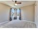 Bedroom features neutral walls, carpet, ceiling fan and natural light from two windows at 341 Thistlewood Dr, Greenfield, IN 46140