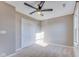 Neutral bedroom features a ceiling fan, carpet flooring, and large closet at 341 Thistlewood Dr, Greenfield, IN 46140