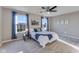 Bright bedroom featuring large windows, a ceiling fan, and cozy decor and carpet flooring at 341 Thistlewood Dr, Greenfield, IN 46140