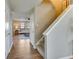 Hallway with hardwood floors, carpeted stairs, and easy access to the living room at 341 Thistlewood Dr, Greenfield, IN 46140