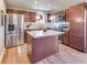 Spacious kitchen with stainless steel appliances, wood cabinets, and central island at 341 Thistlewood Dr, Greenfield, IN 46140