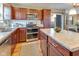 Updated kitchen with wooden cabinets, stainless appliances, and ample counter space at 341 Thistlewood Dr, Greenfield, IN 46140