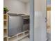 Convenient laundry room with modern washer and dryer units, plus storage shelving at 341 Thistlewood Dr, Greenfield, IN 46140