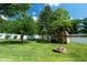 Lush backyard with a storage shed and a stone fire pit at 37 E Waterbury Rd, Indianapolis, IN 46227
